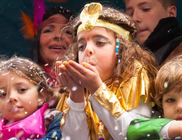 Child dressed up blowing glitter at the Bonheur des Mômes festival Le Grand Bonrand