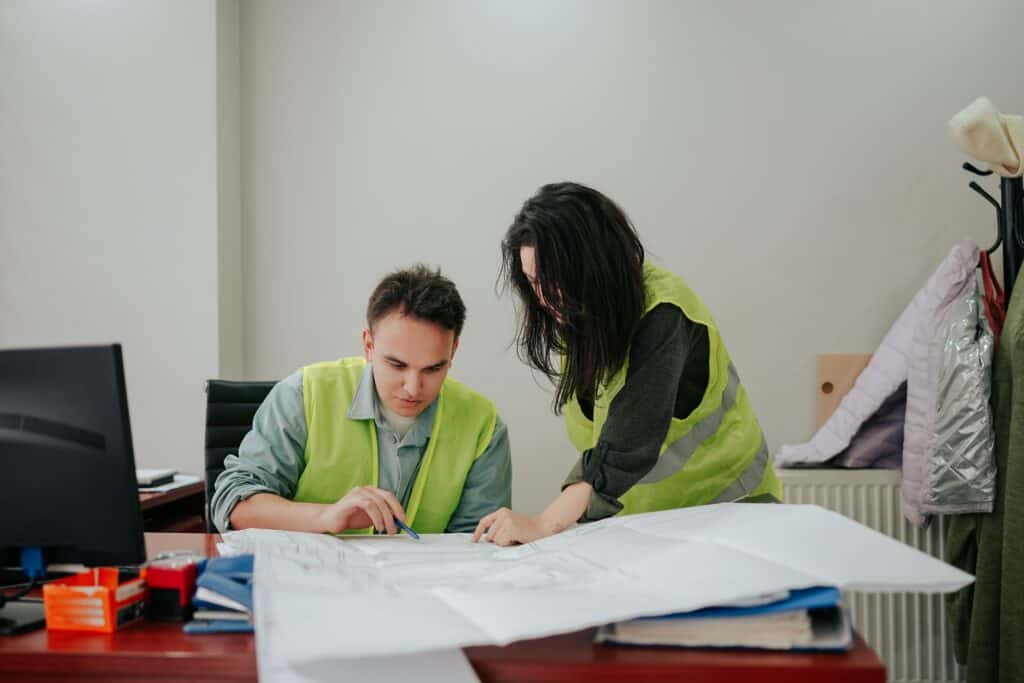 A man and woman look over plans