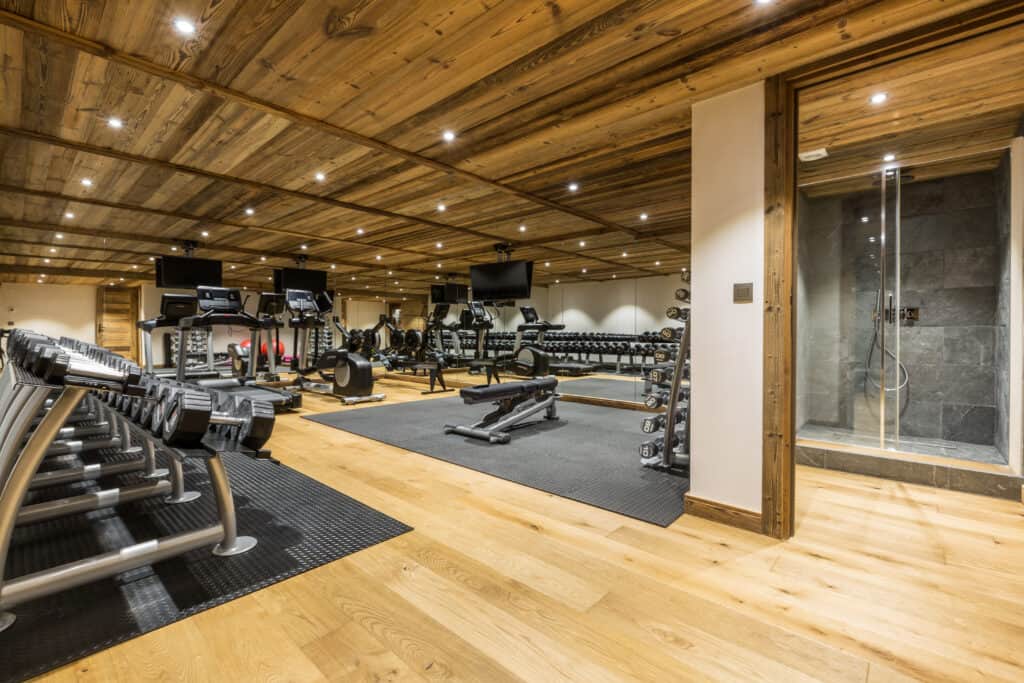 Chalet gym with lots of weights and equipment
