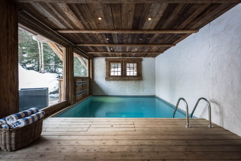 Stunning outdoor swimming pool with wooden ceiling beams