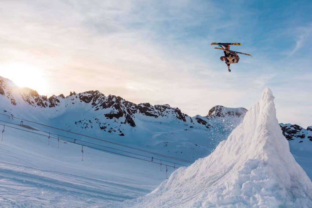 A skier performs an acrobatic trick during a jump on a specially-prepared run. 