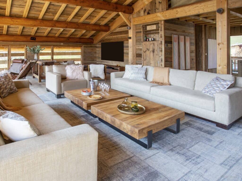 Salon de la Ferme de Mila, avec ses canapés confortables et ses petites tables en bois.