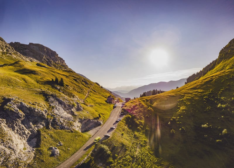 A road passes through the mountains on a sunny day