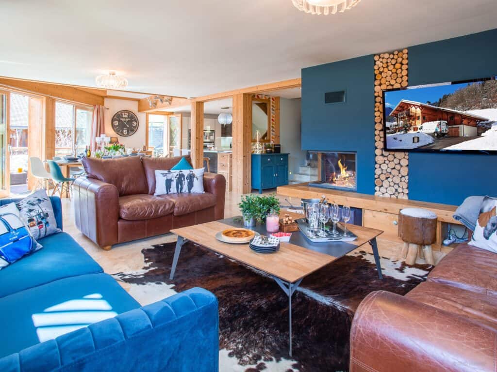 The living area at Chalet Levant Blanc, with a fireplace and mountain views