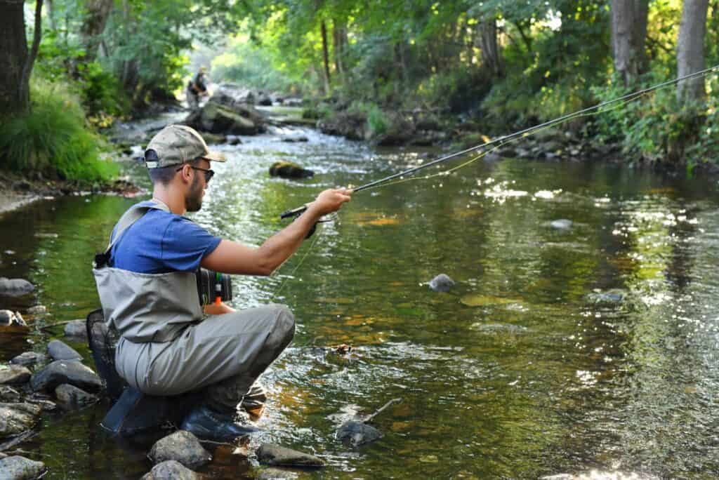 A man fishes in a mountain river