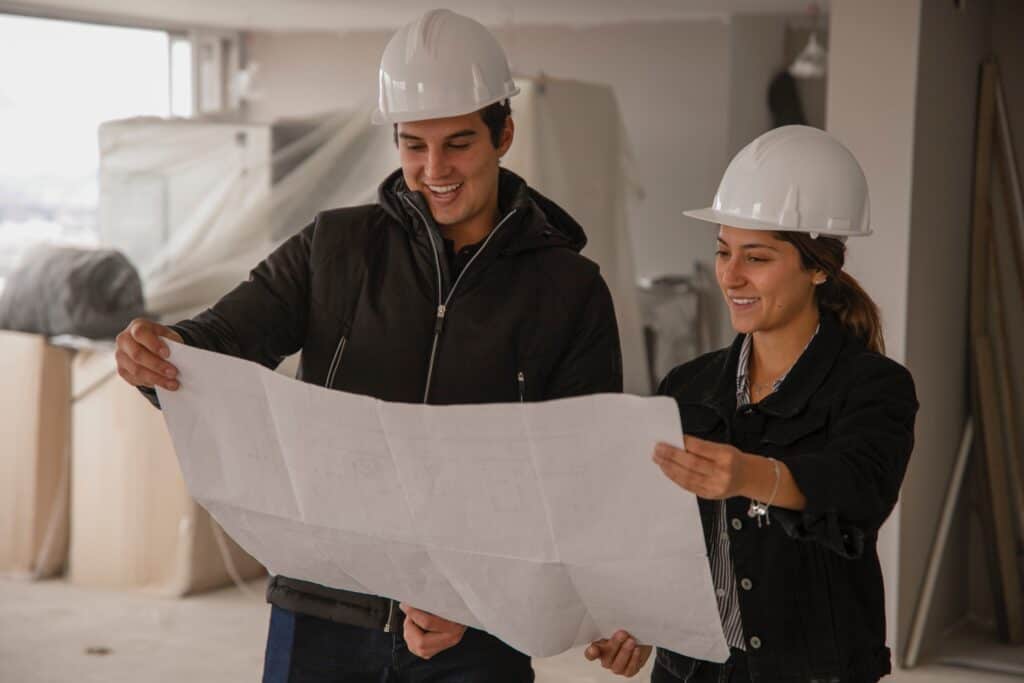 A man and woman look at property plans