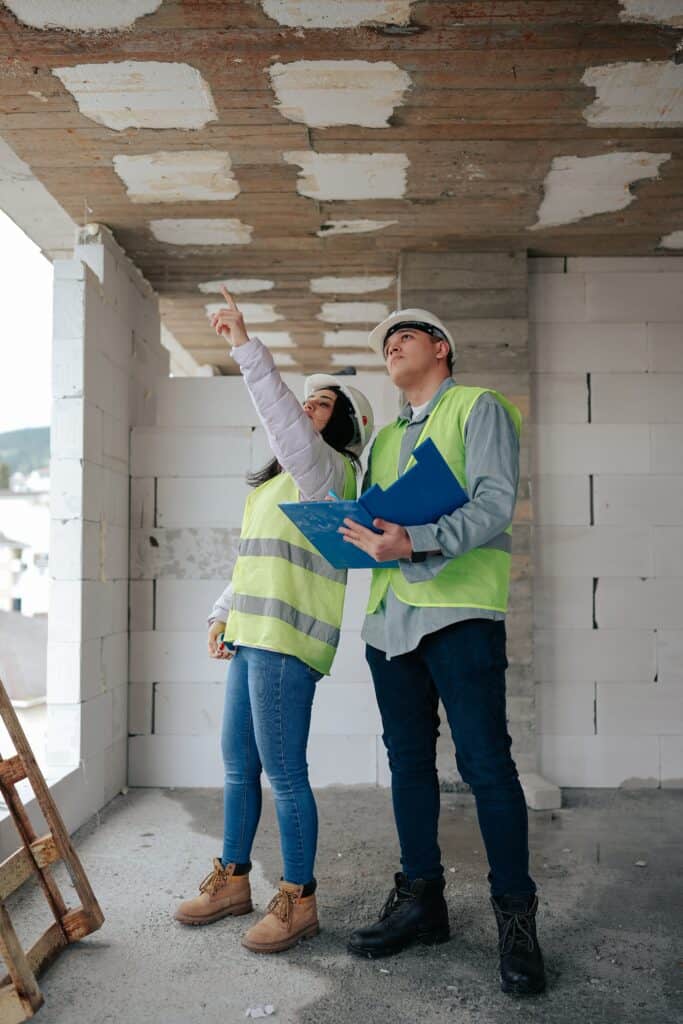 A man and woman assess a building site