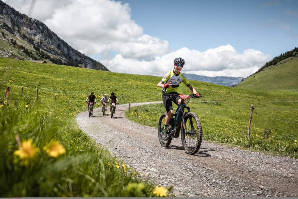 Groupe de personnes faisant du VTT dans les alpages.