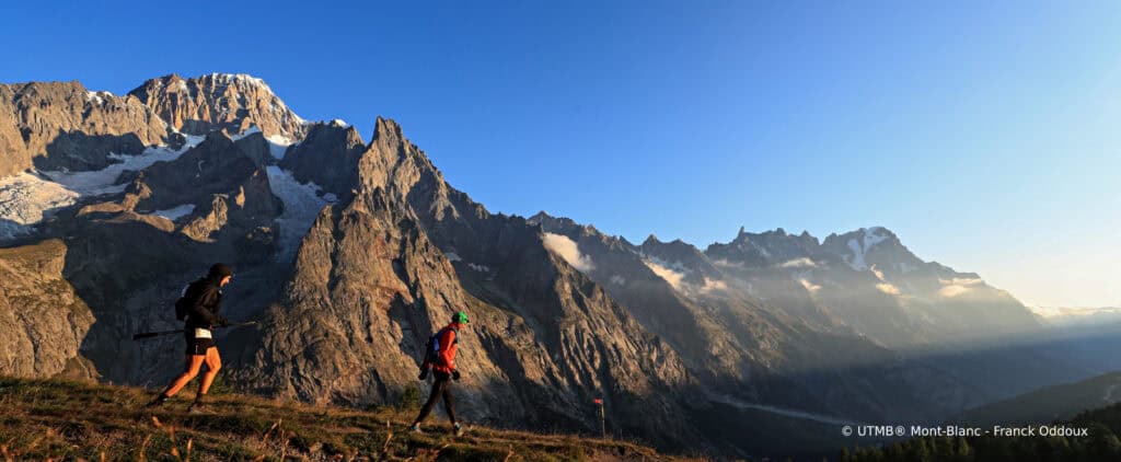 Two people run through the mountains