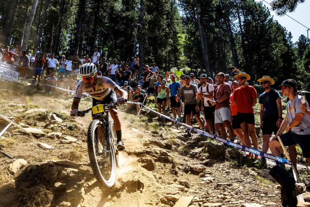 A man rides a mountain bike through a race track