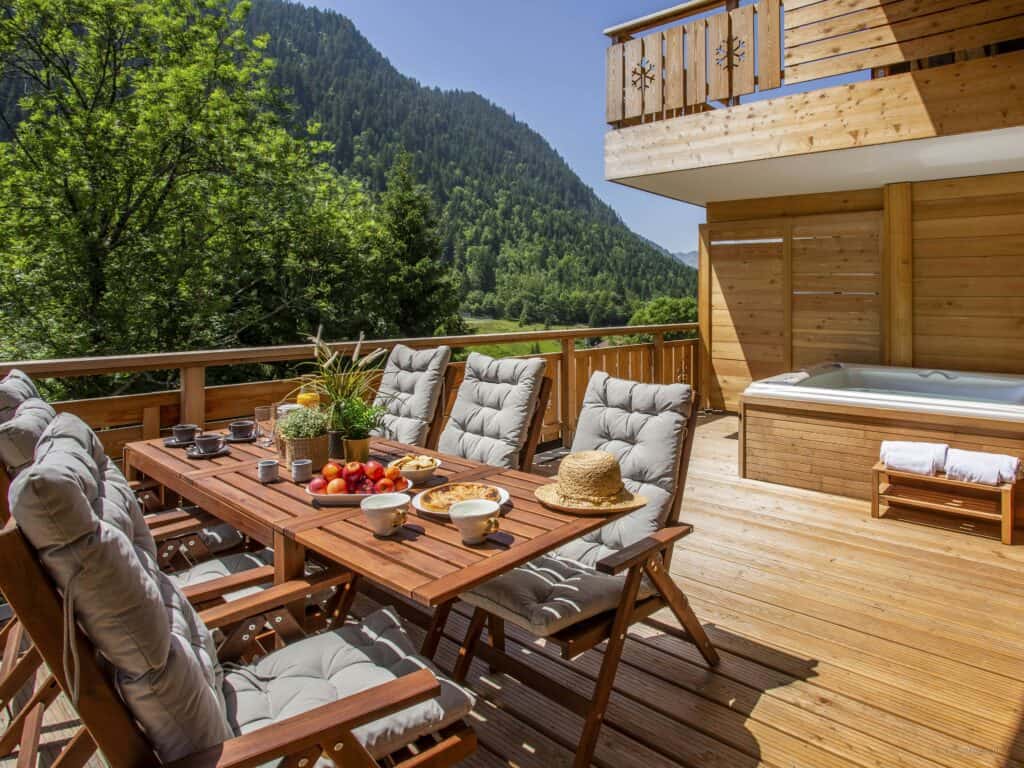 Sunny decking with outdoor dining table and hot tub