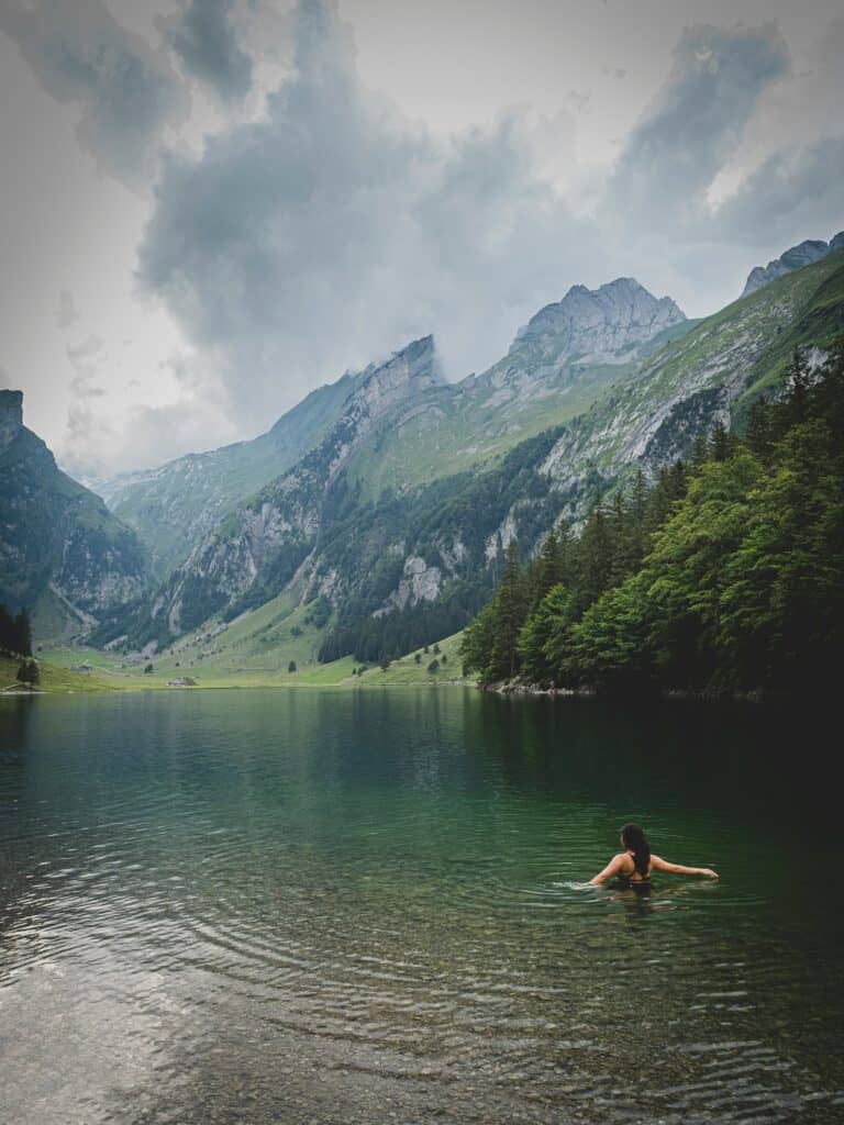 A woman swims in a mountain lake