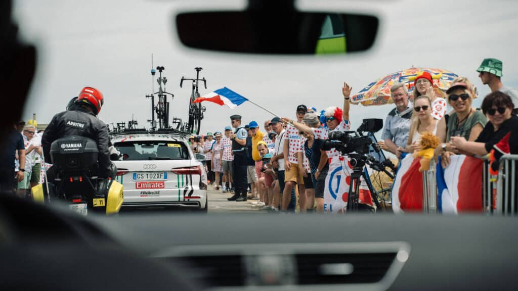 The crowd watching the Tour de France, seen from the inside of a car.