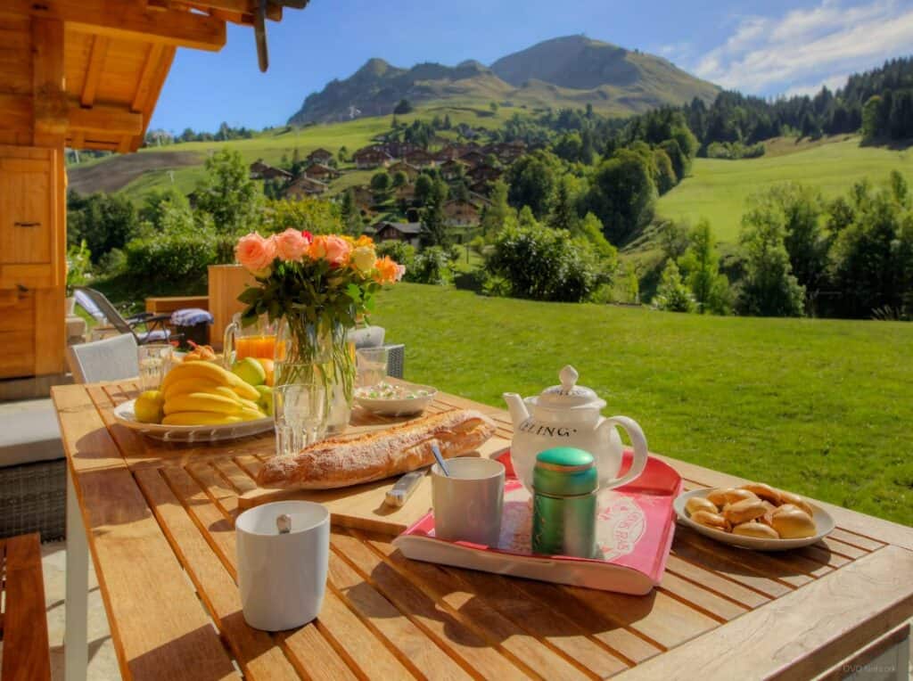 Table dressed for breakfast in the garden of Chalet Tolar, in Grand-Bornand, in the summer.